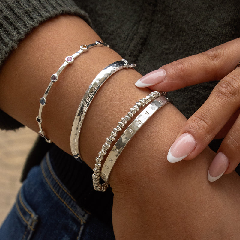Built By The Storm' Hand-Stamped Hammered Bangle in Silver